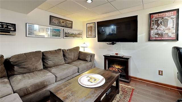 living room with a paneled ceiling