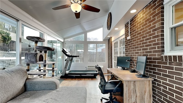 home office with wood-type flooring, brick wall, lofted ceiling, and ceiling fan