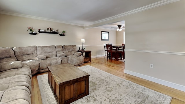 living room with ornamental molding and light hardwood / wood-style flooring