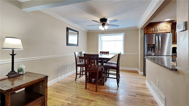 dining space with light hardwood / wood-style flooring, ornamental molding, and ceiling fan