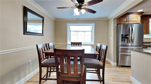 dining space featuring ornamental molding, ceiling fan, and light hardwood / wood-style flooring