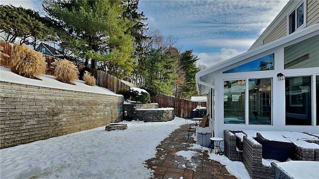 yard layered in snow with an outdoor fire pit