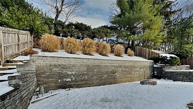 yard layered in snow with a fire pit