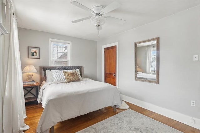 bedroom featuring hardwood / wood-style floors and ceiling fan