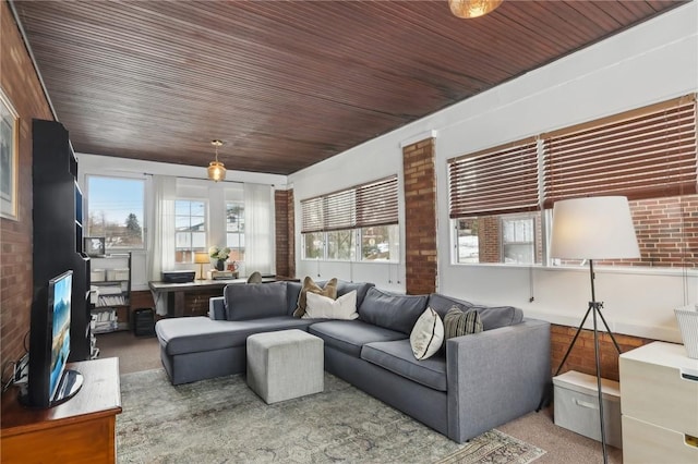 living room with brick wall, carpet floors, and wood ceiling