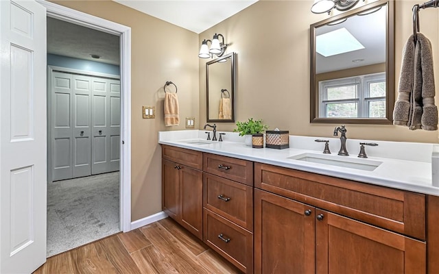 bathroom with vanity and hardwood / wood-style flooring