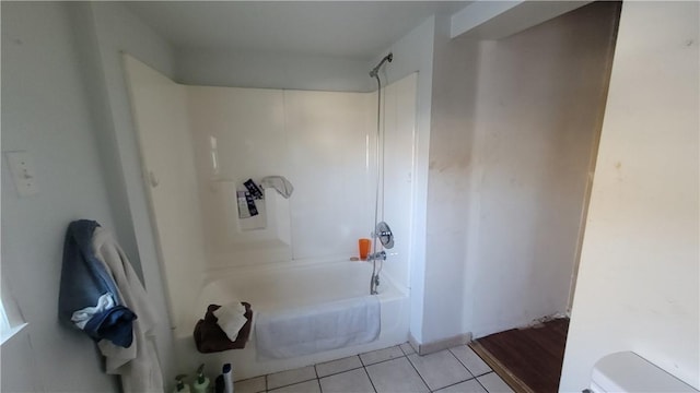 bathroom featuring tile patterned flooring, toilet, and shower / bathing tub combination