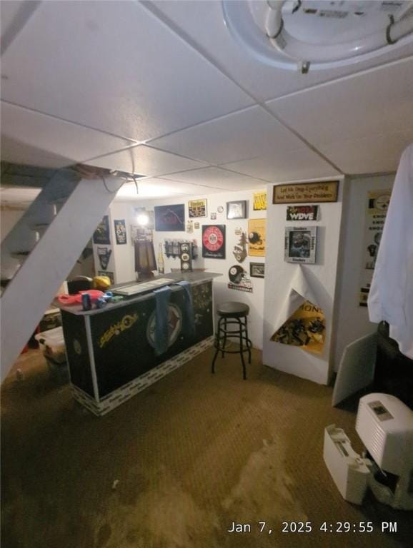 bedroom featuring a paneled ceiling and carpet floors