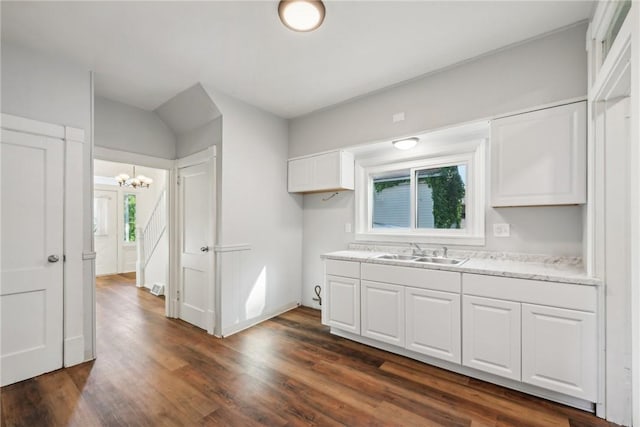 kitchen with sink, dark wood-type flooring, and white cabinets