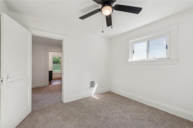 unfurnished room with light colored carpet and a healthy amount of sunlight