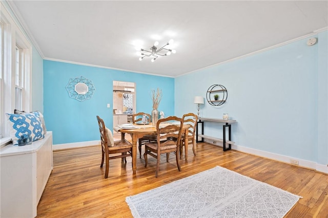 dining area with wood-type flooring and ornamental molding