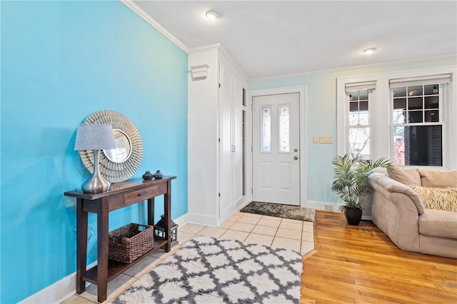 foyer featuring ornamental molding and light hardwood / wood-style flooring