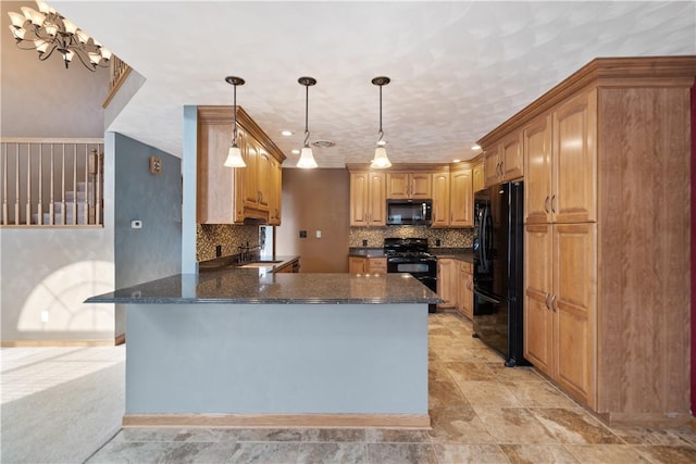 kitchen featuring decorative light fixtures, tasteful backsplash, black appliances, sink, and kitchen peninsula