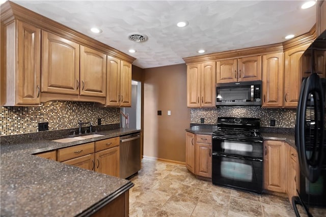 kitchen with dark stone countertops, sink, backsplash, and black appliances