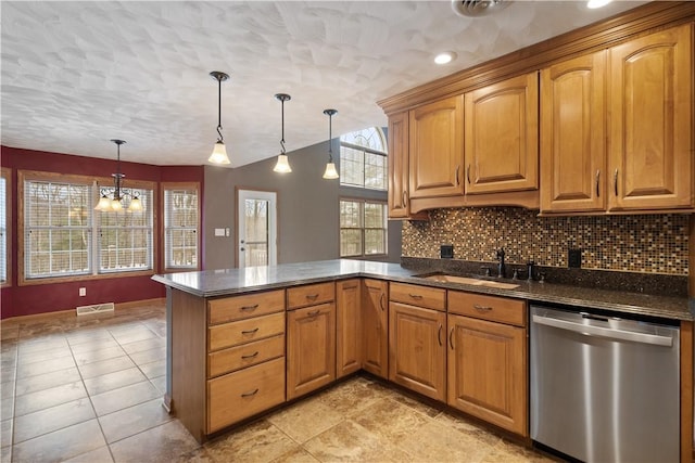 kitchen with pendant lighting, decorative backsplash, dishwasher, and kitchen peninsula