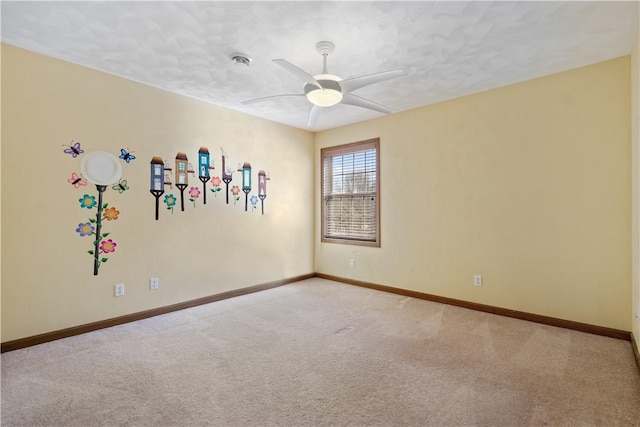 spare room featuring ceiling fan, light colored carpet, and a textured ceiling