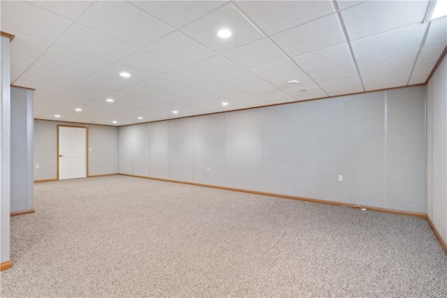 basement with light carpet and a drop ceiling