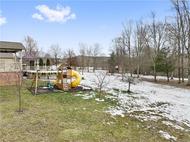 yard covered in snow with a playground and a gazebo