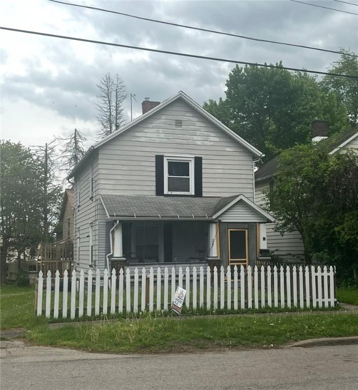 727 S State Line Rd, Sharon, PA 16146 - view of front of house featuring a chimney, roof with shingles, covered porch, and a fenced front yard