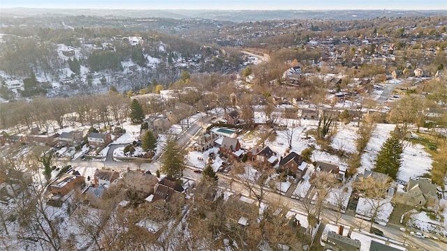 snowy aerial view featuring a residential view