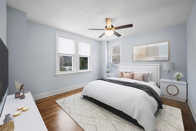 bedroom with dark hardwood / wood-style flooring and ceiling fan