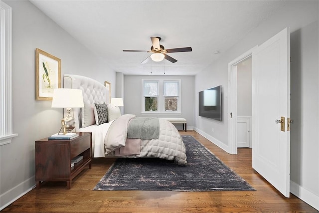 bedroom featuring ceiling fan, wood finished floors, and baseboards