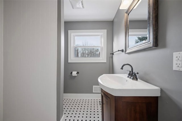 bathroom with visible vents, vanity, a wealth of natural light, and baseboards