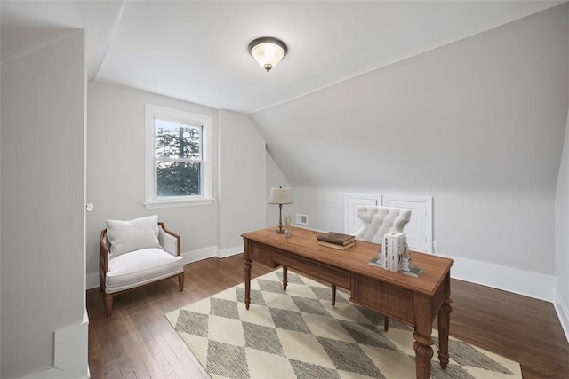 home office featuring lofted ceiling, visible vents, baseboards, and hardwood / wood-style flooring