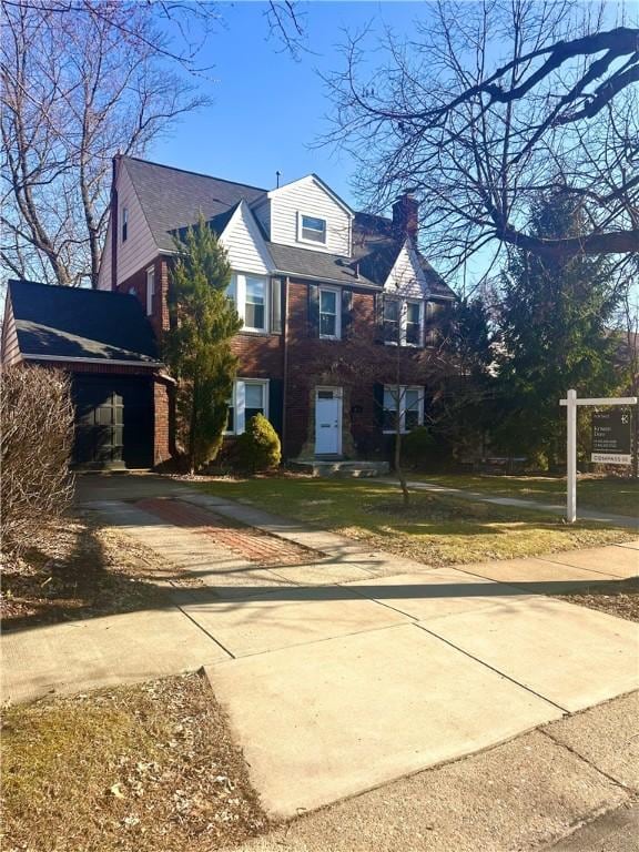 view of front of house featuring driveway and a chimney