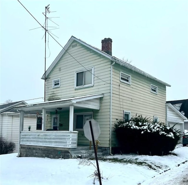 snow covered house with a porch