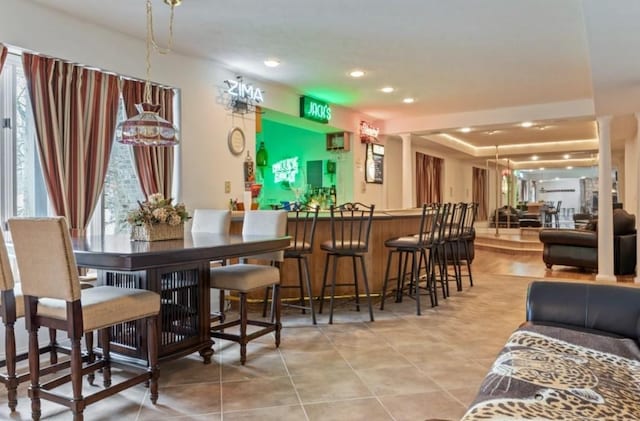 bar featuring ornate columns and a wealth of natural light