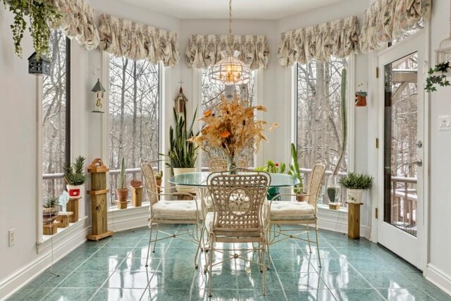 sunroom with a chandelier