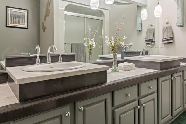 bathroom featuring vanity and a shower with shower door