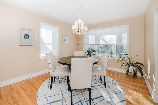 dining area featuring a chandelier and light hardwood / wood-style flooring