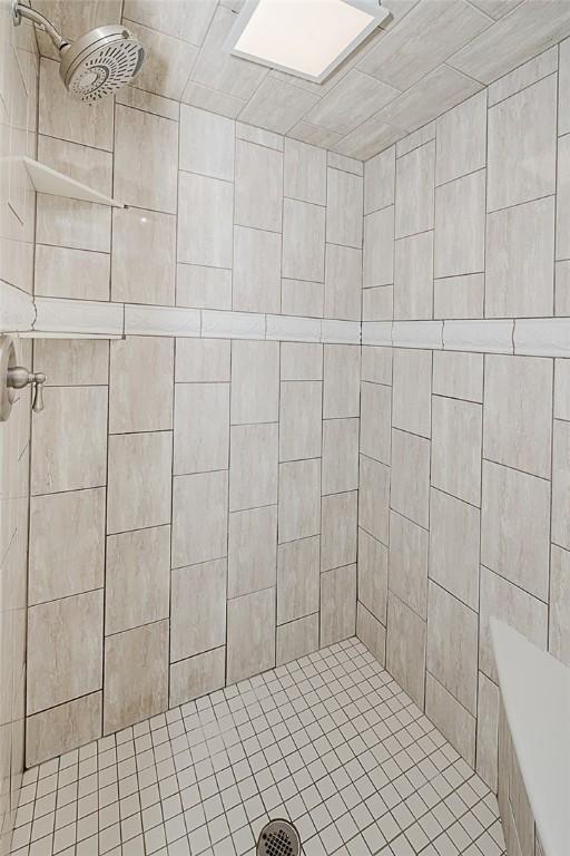 bathroom with a tile shower