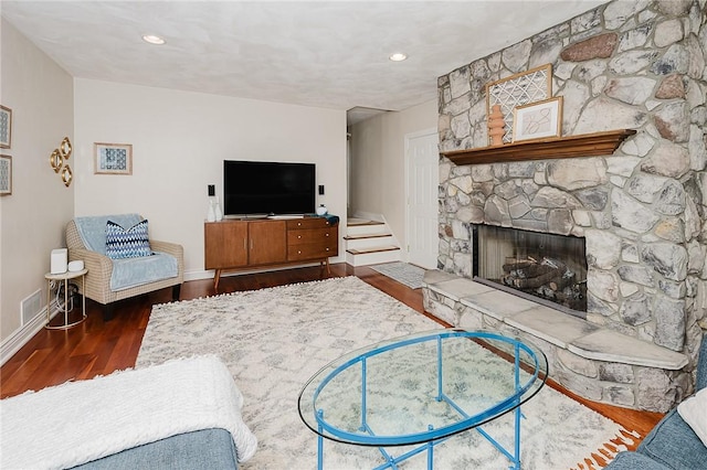 living room featuring a fireplace and dark hardwood / wood-style floors