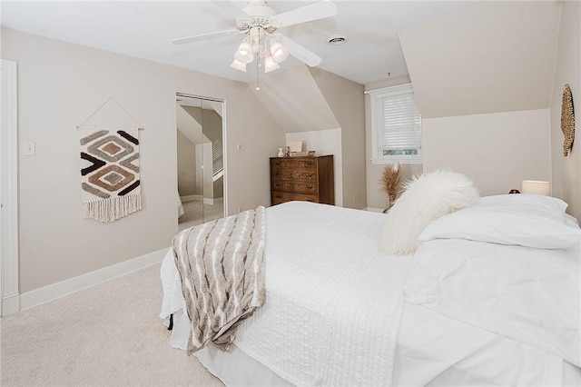 carpeted bedroom featuring vaulted ceiling, ceiling fan, and a closet