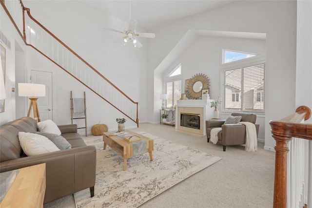 living room featuring carpet floors, high vaulted ceiling, and ceiling fan