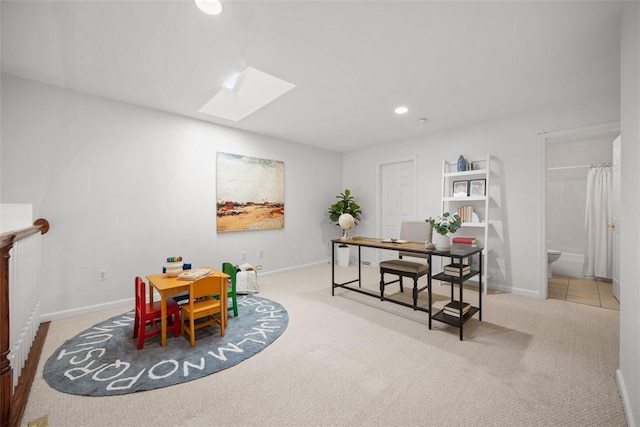 dining area featuring light carpet and a skylight