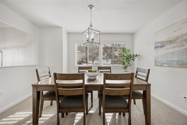 dining area with carpet floors and a chandelier