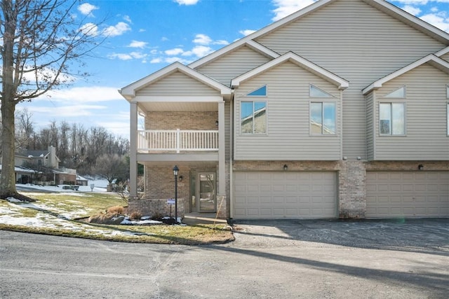 view of front of home with a garage and a balcony