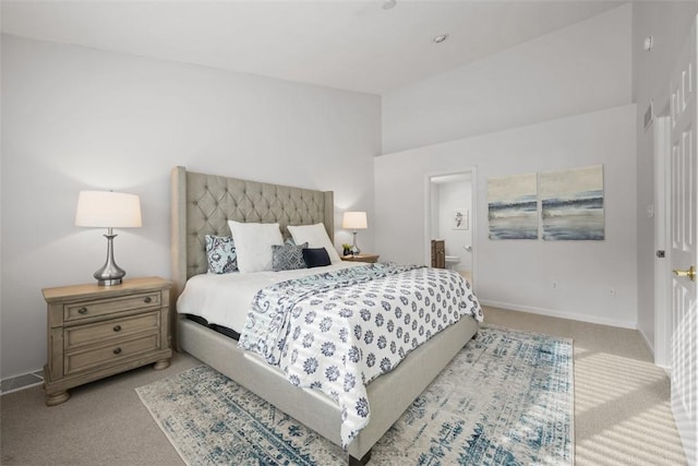 bedroom with light carpet and ensuite bath