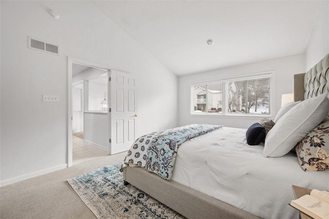 carpeted bedroom with vaulted ceiling