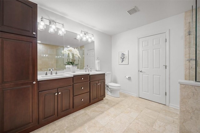 bathroom featuring tiled shower, vanity, and toilet