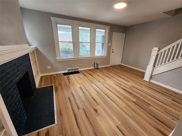 unfurnished living room with light wood-type flooring