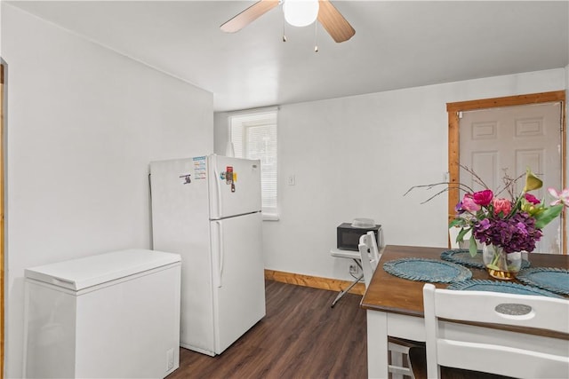 kitchen featuring dark wood-type flooring, white fridge, ceiling fan, and refrigerator