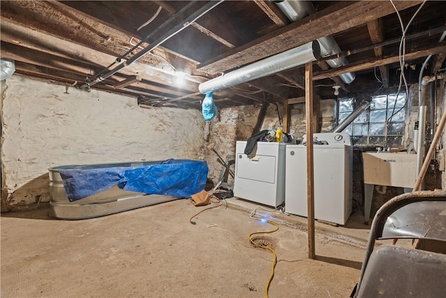 basement with sink and washing machine and dryer