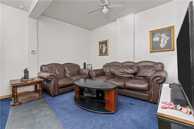 living room featuring ceiling fan and dark colored carpet