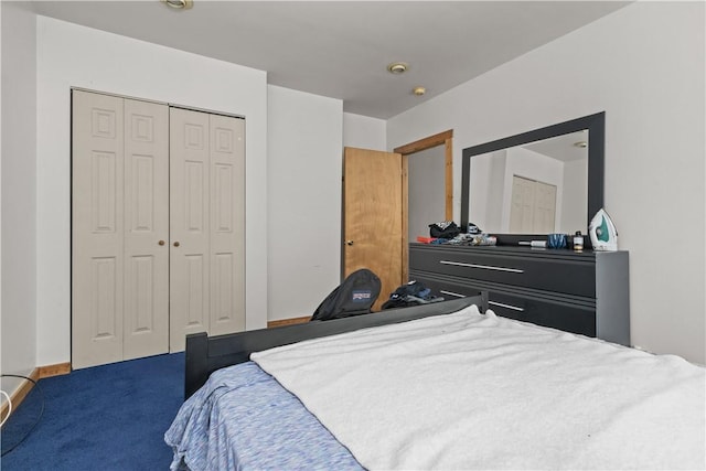 bedroom with dark colored carpet and a closet