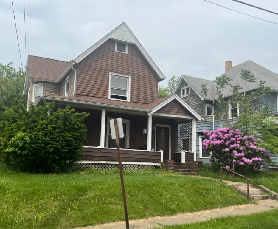 273 Orchard St, Sharon, PA 16146 - view of front of property featuring covered porch, a front lawn, and roof with shingles